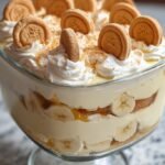 A creamy dish of no-bake banana pudding topped with golden butter cookies