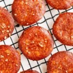 A plate of golden brown crispy pepperoni chips on a white paper towel.