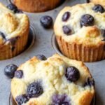 Freshly baked coconut flour blueberry muffins in paper liners on a wire cooling rack