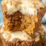 Golden brown keto pumpkin muffins with a hidden cream cheese center on a cooling rack.