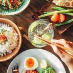 Pan-seared Sugar-Free Lemon Herb Salmon with crispy skin and lemon slices in a cast iron skillet
