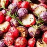 Golden brown roasted radishes in an air fryer basket with dried parsley garnish