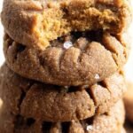 Freshly baked keto almond butter cookies with a fork-press pattern on a parchment-lined baking sheet.
