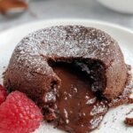 A warm chocolate protein lava cake in a ramekin with a gooey center