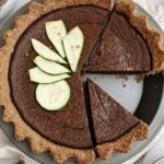 A rich chocolate custard pie in a golden whole wheat crust with shredded zucchini visible in the filling