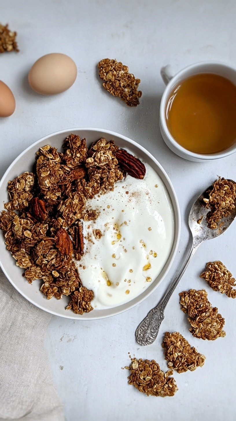 A tray of crunchy maple cinnamon granola broken into large clusters on parchment paper.