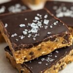 Sliced chickpea cookie dough protein bars with chocolate chips on parchment paper