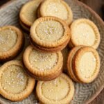Golden brown French butter cookies with fork patterns on a wire rack