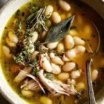 A steaming bowl of Cuban white bean soup with chorizo, potatoes, and greens.