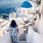Golden brown Santorini tomato fritters served on a plate with fresh herbs and feta cheese