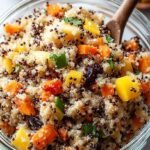 Freshly baked carrot cake muffins with a white cream cheese swirl on a cooling rack