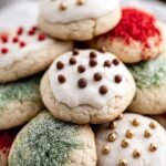 A platter of glazed Italian Christmas Cookies with colorful sprinkles