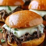 Shredded beef on a toasted hoagie roll with melted provolone cheese and a side of au jus dipping sauce.