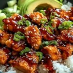 A vibrant bowl of glazed honey-ginger chicken, steamed broccoli, and jasmine rice drizzled with creamy Yum Yum sauce.