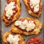 Golden brown crispy air fryer chicken parmesan topped with melted mozzarella and red marinara sauce