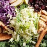 A fresh bowl of Kale Crunch Salad with chopped kale, shredded cabbage, and sliced almonds.