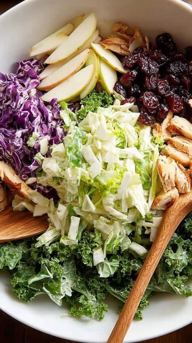A fresh bowl of Kale Crunch Salad with chopped kale, shredded cabbage, and sliced almonds.
