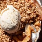 Warm healthy apple crisp in a baking dish with golden oat topping and tender apples.