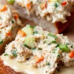 An open-faced air fryer tuna melt on sourdough bread with melted cheddar cheese and fresh celery