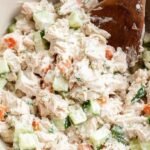 A bright bowl of Mediterranean tuna salad with red onions, celery, and fresh parsley in a lemon vinaigrette.