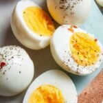 A bowl of perfectly peeled hard boiled eggs made in an air fryer.