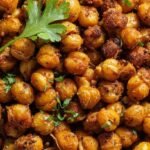 Golden brown seasoned chickpeas in an air fryer basket