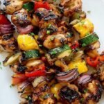 Grilled honey soy chicken kabobs with peppers and pineapple on a platter