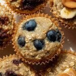 Golden brown banana oat blender muffins with chocolate chips on a wire rack