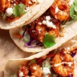 Crispy beer-battered shrimp in corn tortillas with cabbage slaw and chipotle crema