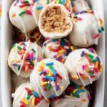 A plate of colorful healthy birthday cake truffles with rainbow sprinkles