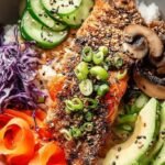 Baked furikake salmon fillets with a creamy glaze and seaweed seasoning on a baking sheet