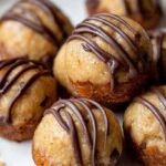 A tray of golden brown mini banana bread bites on a wire cooling rack