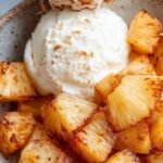 Golden caramelized pineapple wedges with cinnamon sugar in an air fryer basket