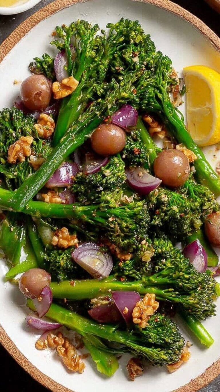 A bowl of creamy broccolini salad with bacon, dried cranberries, and sunflower seeds.
