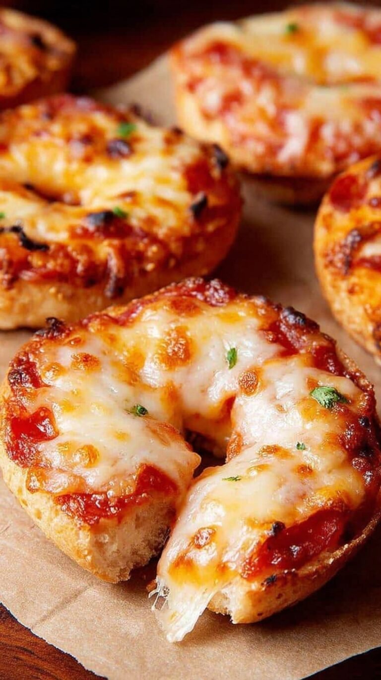 A plate of golden, crispy air fryer bagel bites with melted cheese and pepperoni.