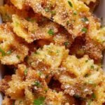 Golden brown and crispy air fryer pasta chips seasoned with parmesan and herbs in a bowl