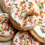 Soft frosted sugar cookies with natural sprinkles on a white plate
