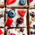 Close up of sliced frozen yogurt granola bars with blueberries and chocolate chips on parchment paper