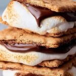Golden brown toasted marshmallows on graham crackers with melted chocolate inside an air fryer