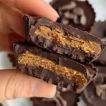 Mini dark chocolate cups filled with spiced pumpkin puree on a wooden board.