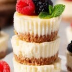 Mini protein cheesecakes in a muffin tin with graham cracker crust