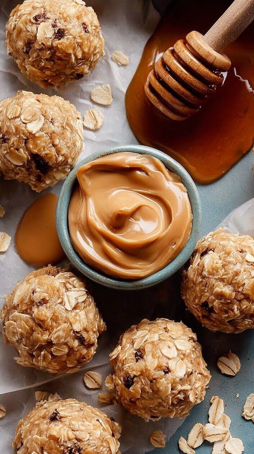 Close up of smooth peanut butter oatmeal balls stacked on a white plate