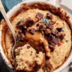 A golden brown ramekin of air fryer baked oats topped with melted chocolate chips.