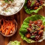 A skillet of Spicy Chicken Bulgogi topped with green onions and sesame seeds