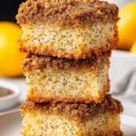 A slice of lemon poppy seed cake with an oat crumble topping on a white plate.