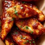 Golden seasoned chicken tenders cooked in an air fryer without breading