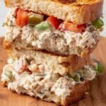 A golden-brown healthy tuna melt sandwich with melted mozzarella and spinach on whole-grain bread.