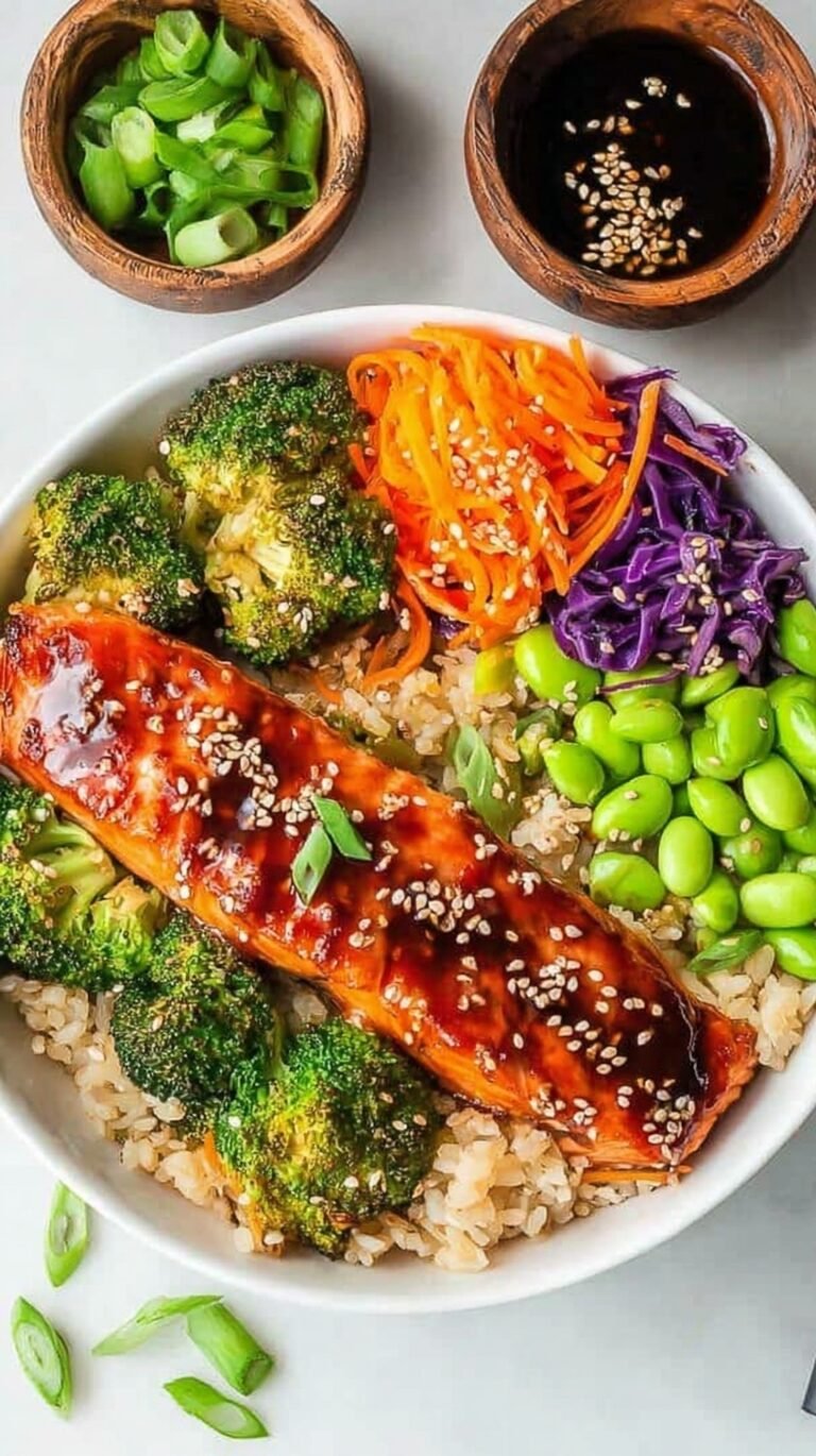 Two colorful Teriyaki Salmon Buddha Bowls with glazed salmon, avocado, and fresh vegetables over brown rice.