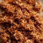 Golden brown air fryer granola with sliced almonds in a bowl
