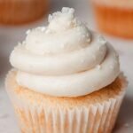 Fluffy vanilla buttercream frosting swirled on top of a healthy cupcake